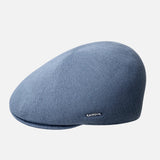 Blue flat cap with 'Kangol' branding on a light gray background