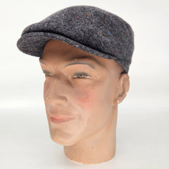 Mannequin head wearing a gray tweed cap on a white background