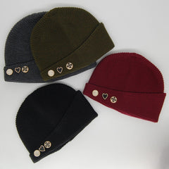 Four knit beanie hats in different colors with decorative buttons on a light gray background