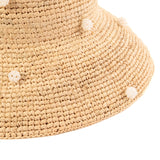 natural crochet raffia straw hat with white pearl beads on a white background