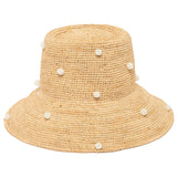 natural crochet raffia straw hat with white pearl beads on a white background