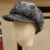 TEXTURED NAVY WOOL cap on a mannequin head against a neutral background